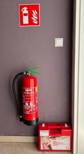 a red fire extinguisher and a box in a drawer at Villa Sonnenpiste in Kötschach