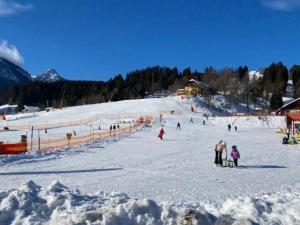 a group of people skiing down a snow covered slope at Villa Sonnenpiste in Kötschach