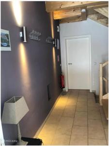 a hallway with a white door and a lamp at Villa Sonnenpiste in Kötschach