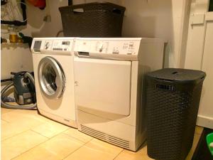 a washing machine sitting next to a trash can at Villa Sonnenpiste in Kötschach