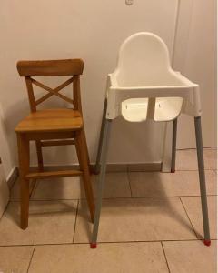 a chair and a wooden chair next to a stool at Villa Sonnenpiste in Kötschach