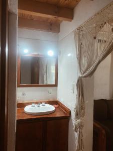 a bathroom with a sink and a mirror at Cabaña Los Angeles in Villa General Belgrano