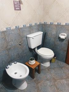 a bathroom with a toilet and a sink at Cabaña Los Angeles in Villa General Belgrano +42 photos