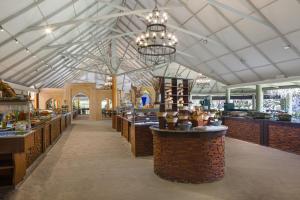 a restaurant with a large ceiling with chandeliers at Beach Villa - The Maldives in North Male Atoll
