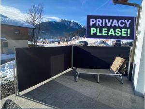 a sign that reads privacy please next to a fence at Villa Sonnenpiste in Kötschach