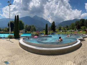a large swimming pool with people in it at Villa Sonnenpiste in Kötschach
