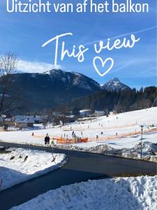 a winter view of a mountain with the words this view at Villa Sonnenpiste in Kötschach