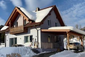a house with snow on the roof at Villa Sonnenpiste in Kötschach