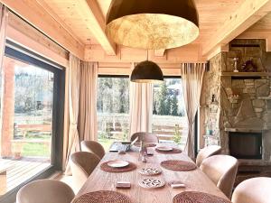 a dining room with a table and a large window at Dom Bio - Unique Ski Chalet, Białka Tatrzańska, Slovakia, Zakopane in Białka Tatrzanska