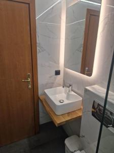 a bathroom with a white sink and a mirror at Adi's House in Kalamitsi +6 photos