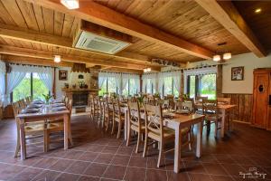 a large dining room with wooden tables and chairs at Zagroda Magija Bieszczady in Orelec