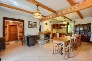 a kitchen with a table and a fireplace at Zagroda Magija Bieszczady in Orelec +36 photos