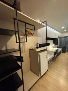a small room with a refrigerator and a bunk bed at Cha-am , Cityscape Comfort , Near Cha-am Beach South in Cha Am