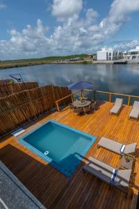 a swimming pool on the deck of a boat at Bahia Soul - Casa Ayla - Barra Grande - Península de Maraú in Marau
