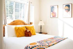 a bedroom with a large bed with yellow pillows at Heaven Heights - HotTub, Pet Friendly, EV Outlet, Pool Table, Game Room, BBQ, FirePit, Library in Oakhurst