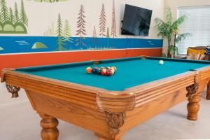 a pool table with balls on top of it at Heaven Heights - HotTub, Pet Friendly, EV Outlet, Pool Table, Game Room, BBQ, FirePit, Library in Oakhurst