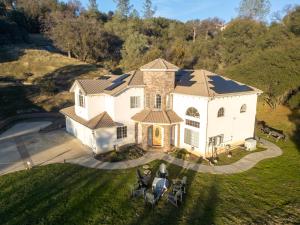 an aerial view of a large white house at Heaven Heights - HotTub, Pet Friendly, EV Outlet, Pool Table, Game Room, BBQ, FirePit, Library in Oakhurst