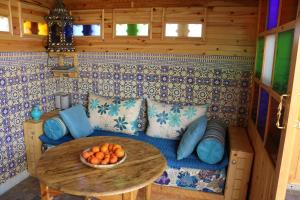 a living room with a couch and a table at Riad Les Chtis D'Agadir in Agadir