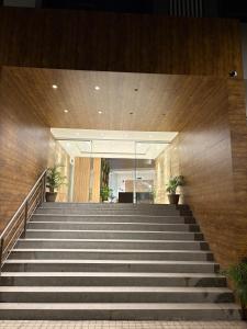 a staircase leading up to a building with potted plants at Elegant Escape , the complete home in Pune