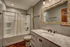 a bathroom with a sink and a toilet and a mirror at Eagles Haven in Eagle River