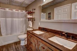 a bathroom with two sinks and a toilet and a mirror at Eagles Haven in Eagle River