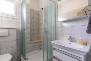 a bathroom with a sink and a shower at Holiday house Martinović in Prigradica +32 photos
