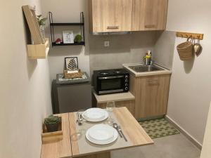 a small kitchen with a table with plates on it at ΑΡΜΟΝΙΑ-Harmony in Veria