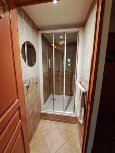 a bathroom with a shower with a glass door at Le Corbier, T3, 4-6 pers in Villarembert