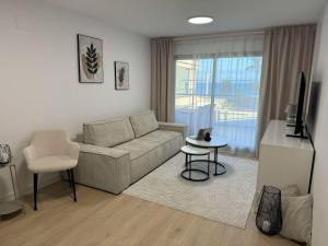 a living room with a couch and a chair at Apartament Premium Hipocampos in Ifach