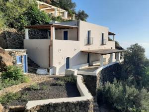 a house on the side of a hill at L'Olivuzza in Alicudi