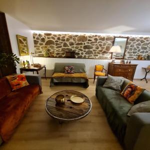 a living room with couches and a coffee table at Appartement Puy Mary By les Monts du Cantal in Murat