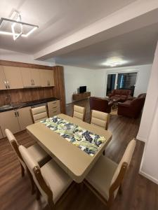 a kitchen and dining room with a table and chairs at New Apartment 10th floor with view in Ferizaj