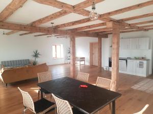 a living room with a black table and chairs at Am Kapferhof in Hauzenberg +18 photos
