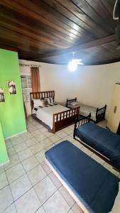 a bedroom with two beds and two meditation mats at Posada Verde Balneario Caragua in Caraguatatuba