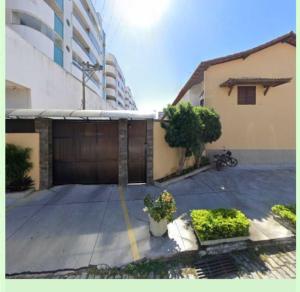 a parking lot with a garage and a building at Casa Amar Cabo Frio in Cabo Frio