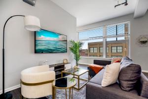 a living room with a couch and a table at Chic 2BR-Parking, Rooftop,Near Arrowhd & TMobile in Kansas City