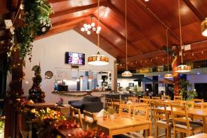 a dining room with wooden tables and chairs at Yasmin Luxury Resort in Paramaribo