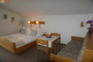 a hotel room with a bed and a table and a table at Pension Andrea in Sankt Peter im Sulmtal