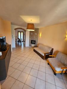 a living room with couches and a tv and a fireplace at Villa Marta in Città della Pieve +48 photos