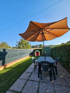 a table with an umbrella on a patio at Villa Marta in Città della Pieve