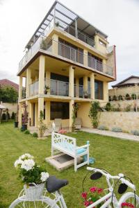 a house with a white bench in the yard at Villa SeaBreeze in Varna City
