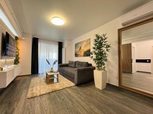 a living room with a couch and a large mirror at Bucharest Premium Luxury Studios & Apartments by Glam Story in Bucharest