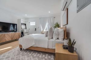 a bedroom with a large bed and a television at Brand New Apt W Parking Blocks From Downtown- A in Sunnyvale