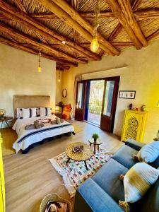 a bedroom with a bed and a living room at Soo Bin in Bine el Ouidane +255 photos
