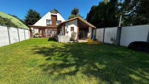 a house with a bunch of bananas in a yard at heated pool, barbecue area and full house in Licán Ray