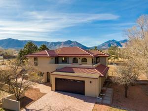 a house with a garage with mountains in the background at Flagstaff Family Retreat in Flagstaff