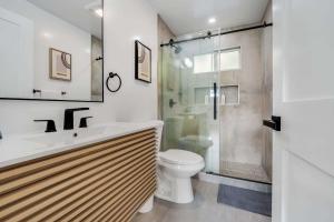 a bathroom with a toilet and a glass shower at Brand New Apt W Parking Blocks From Downtown- F in Sunnyvale +24 photos