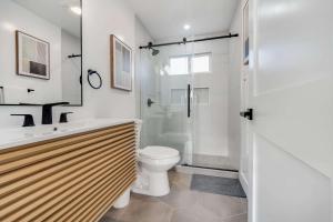 a bathroom with a shower and a toilet and a sink at Brand New Apt W Parking Blocks From Downtown- D in Sunnyvale +24 photos