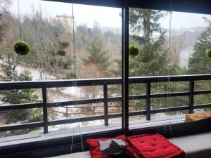 a room with a large window with red pillows at chalet LES GRANDES TERRES in Enchastrayes