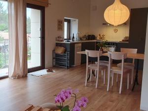 a kitchen and dining room with a table and chairs at Château les Poules in Assignan +16 photos
